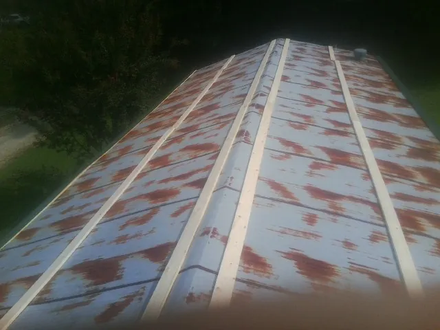 Rusted metal roof panels with new wood purlins before replacement — Storm Damage Roof Repair in Randolph by Roofing Brothers